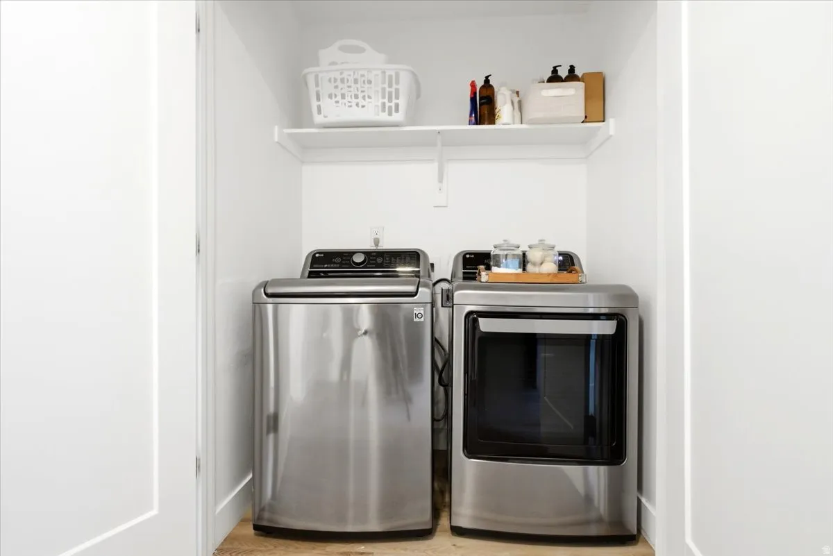 Dedicated laundry area featuring a stainless steel top-load washer and front-load dryer