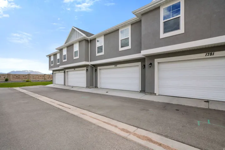 Multi-unit property with a stucco exterior and white trim