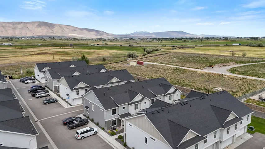 Modern townhome development featuring uniform architecture with dark shingle roofs