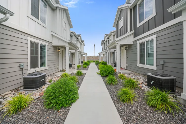 Modern townhome exterior featuring gray horizontal siding and vertical white accents