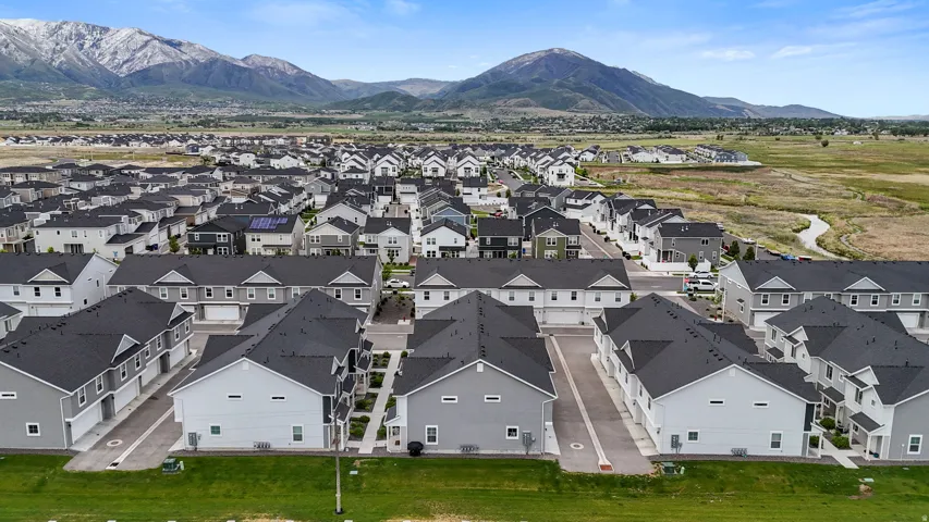 Contemporary residential development with varied architectural styles set against a mountain backdrop