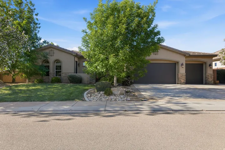Stucco exterior with stone accents and a tile roof