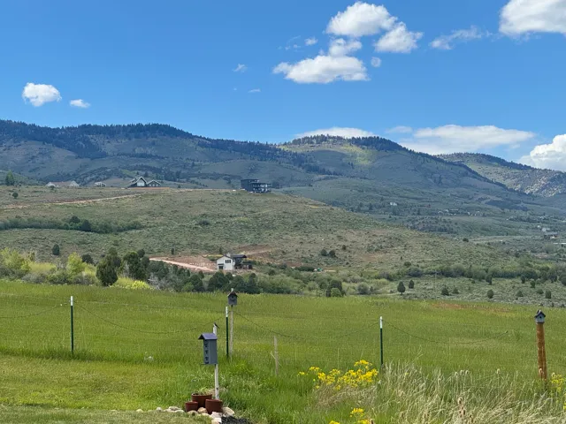 Expansive undeveloped land featuring rolling hills and distant mountain ranges