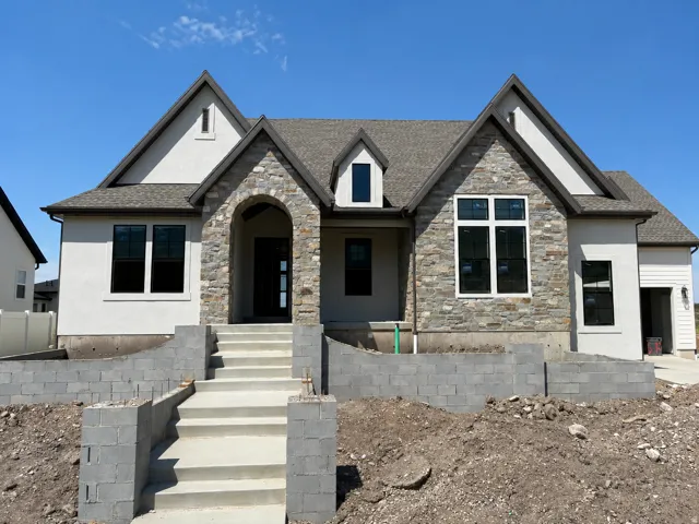 Stone and stucco exterior with multiple gables and dark trim accents