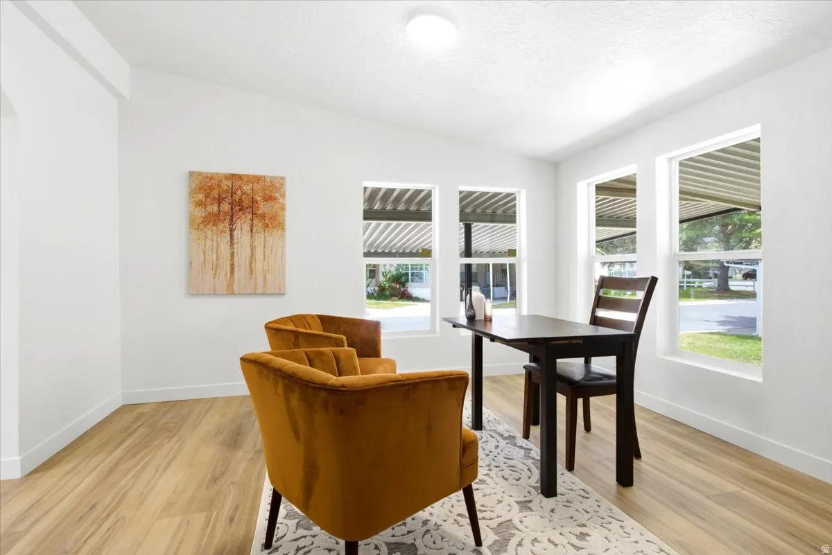 Bright interior space featuring light wood-finish flooring and white walls