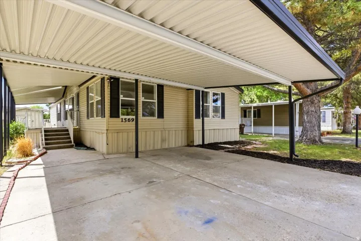 Covered carport featuring a concrete pad and direct access to the residence