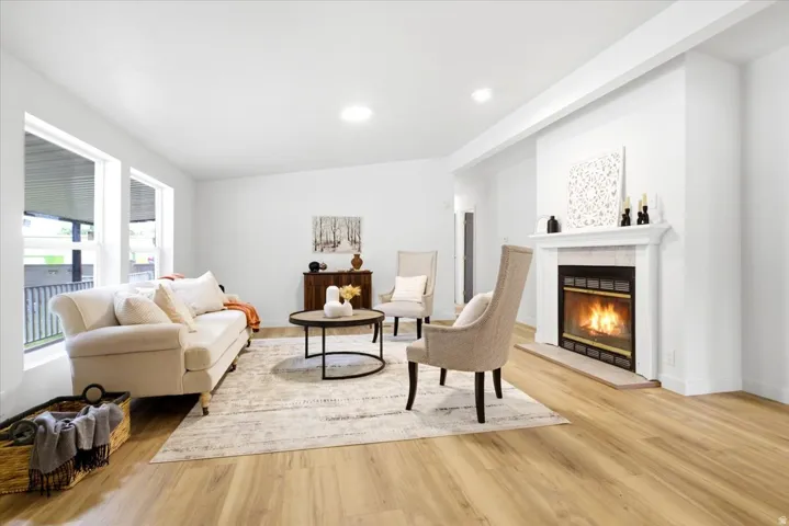 Living area featuring light wood-finish flooring and recessed lighting