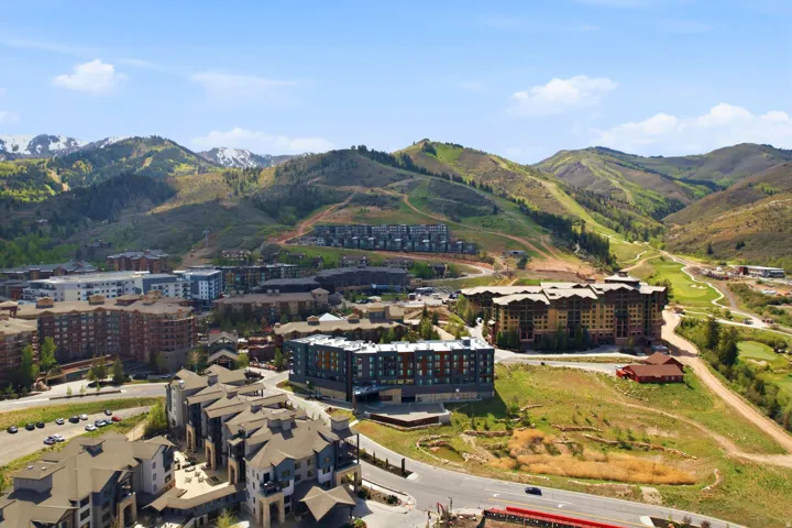 Expansive mountain landscape featuring multiple residential complexes and golf course elements