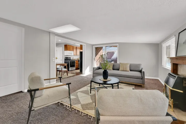 Open-concept living space featuring carpet flooring and light gray walls