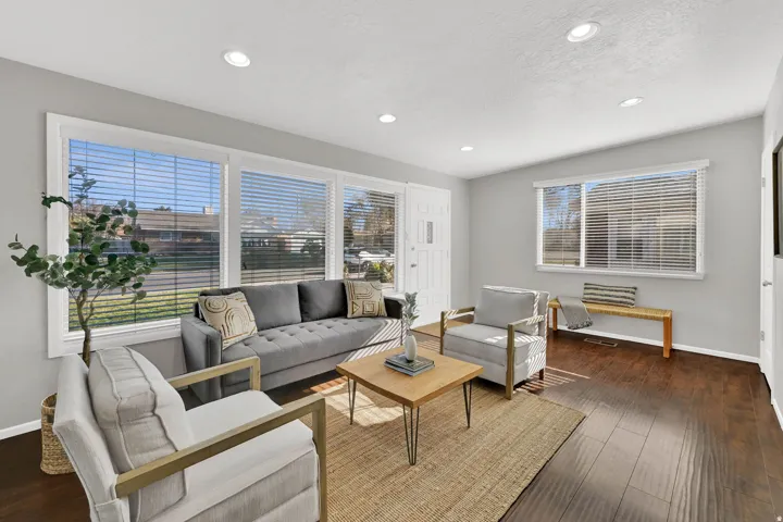 Bright living area featuring wood-finish flooring and recessed lighting