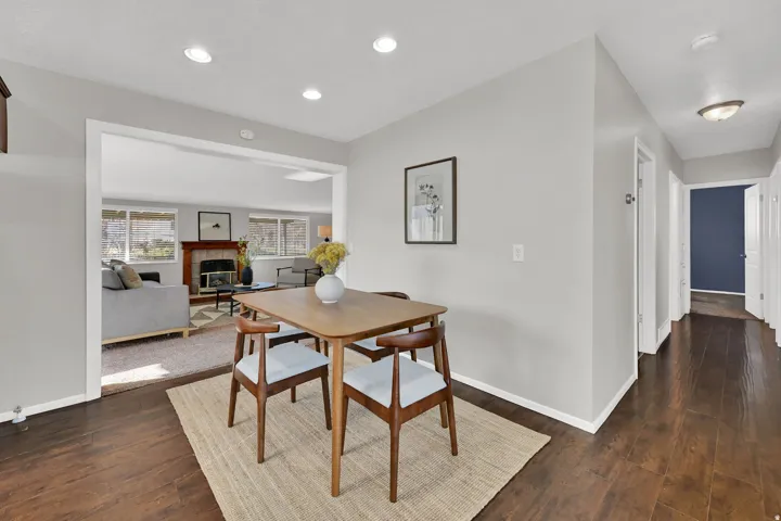Open concept dining area featuring wood-finish flooring, recessed lighting, and a neutral color palette