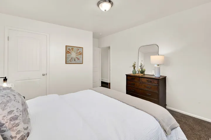 White painted walls and trim, wood-paneled interior door, and a built-in overhead light fixture