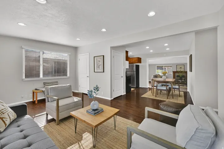 Bright living space featuring wood-finish flooring and recessed lighting