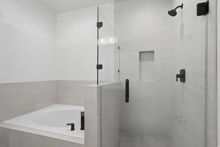 Soaking tub with sleek black fixtures