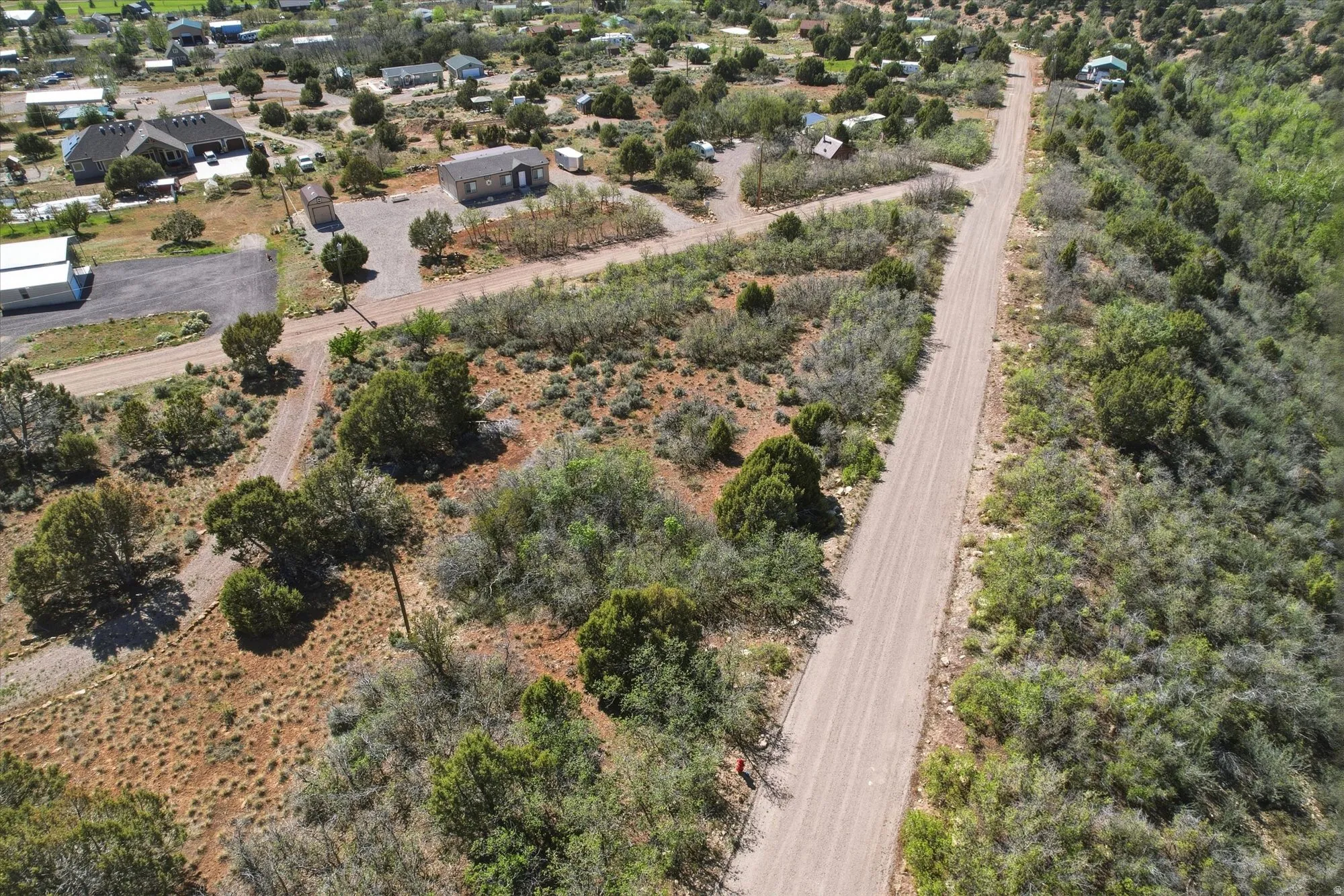 Expansive undeveloped land featuring natural vegetation and established dirt roads