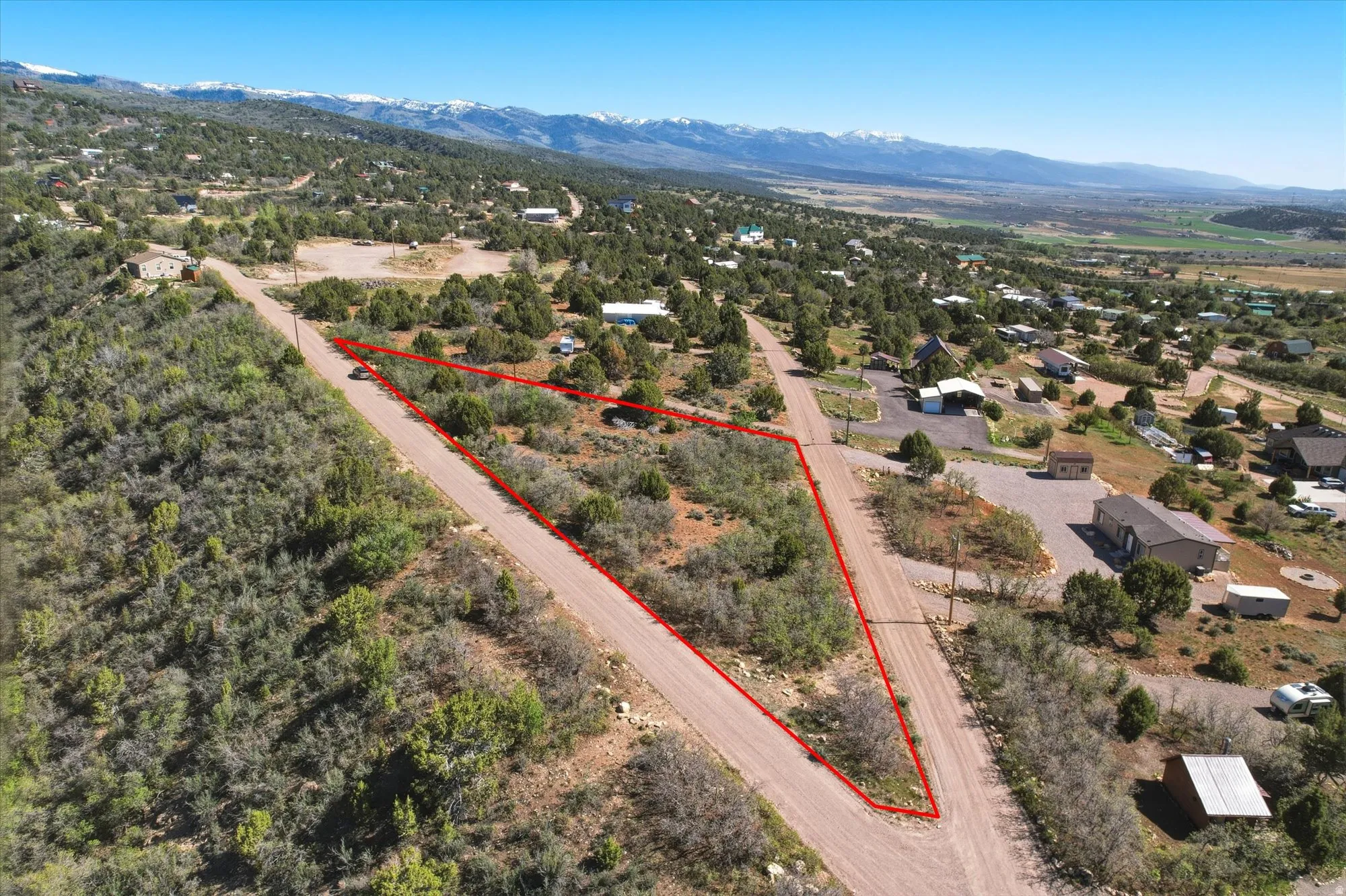 Expansive land parcel featuring natural vegetation and surrounding roads
