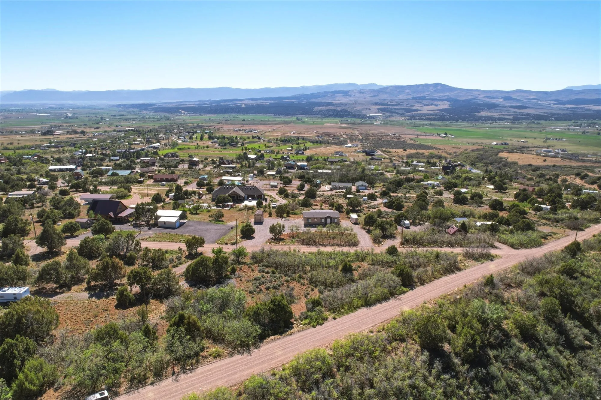 Expansive aerial perspective showcasing a rural landscape with scattered residential structures