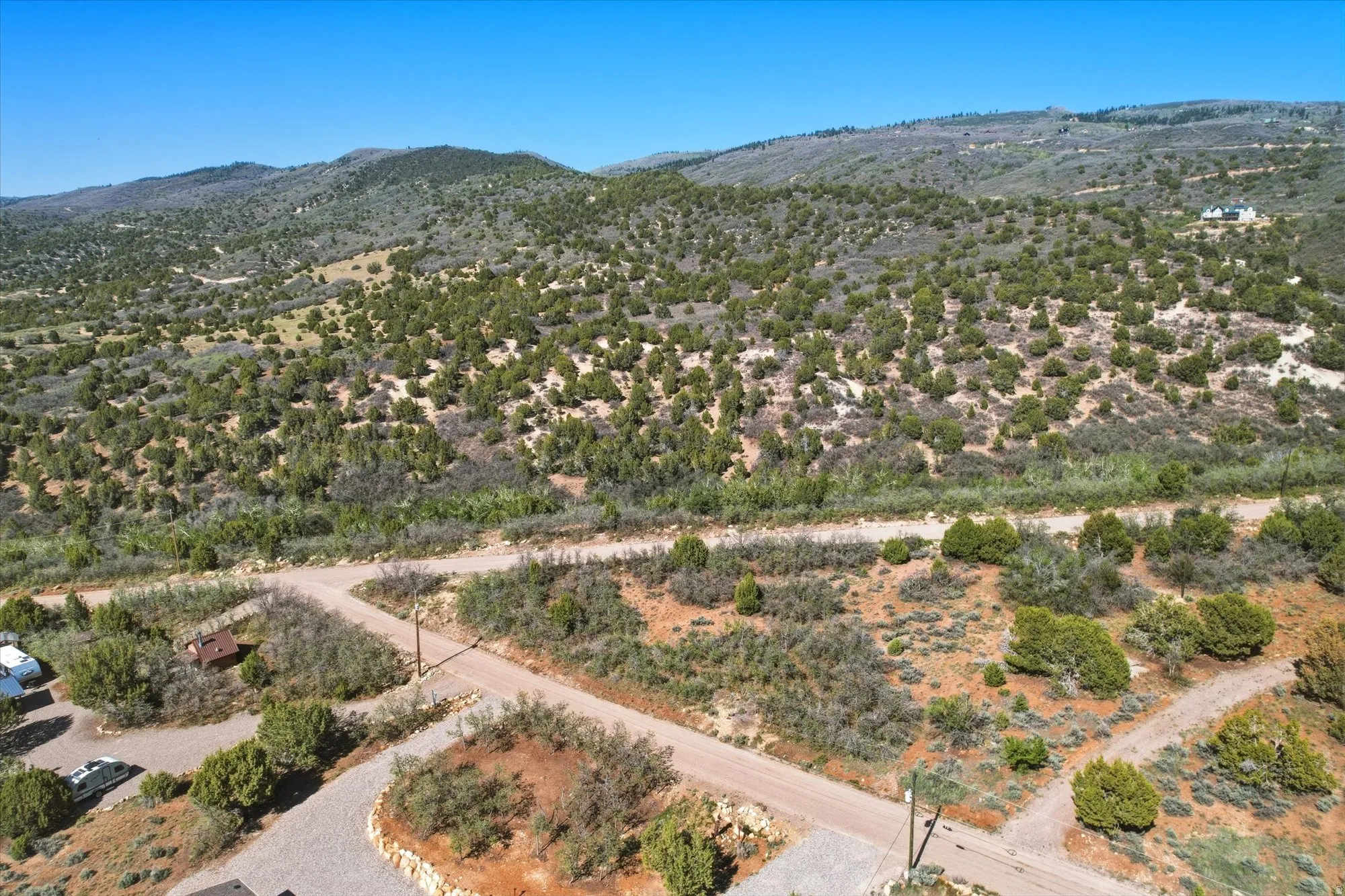 Expansive natural landscape featuring rolling hills and abundant green vegetation