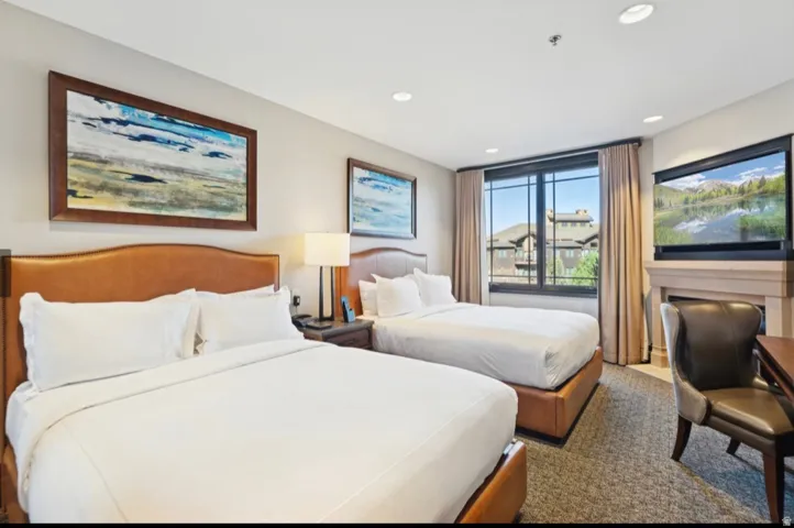 Two beds with leather-finish headboards and bases