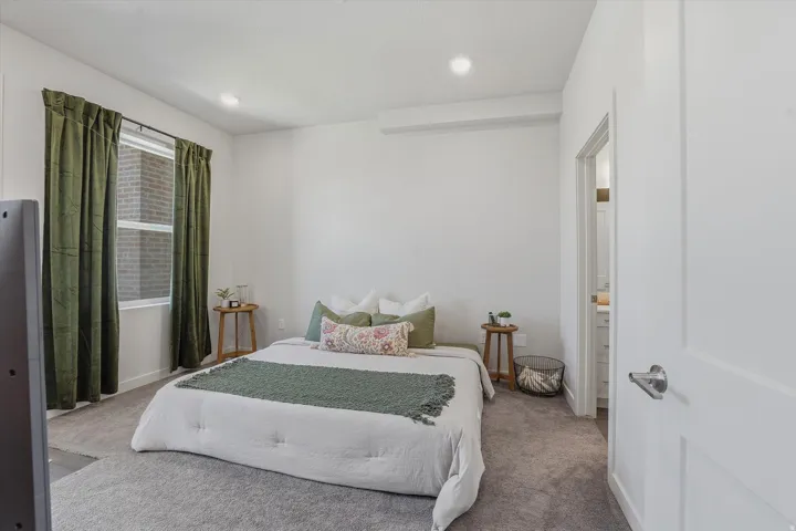 Carpeted room with a flush-mount ceiling light and a window with white trim