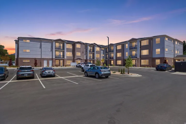 Contemporary multi-story building featuring brick and horizontal siding facades
