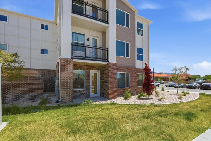 Multi-story exterior featuring brick and panel siding