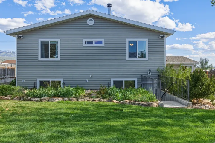Expansive green lawn with a rock garden and established plantings