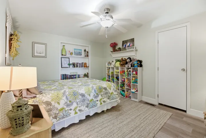 Neutral-toned room featuring light gray walls and wood-finish flooring