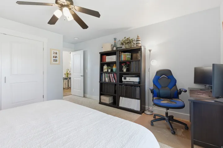 Bedroom featuring a ceiling fan, light gray wall paint, and carpeted flooring