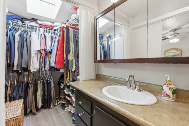 Vanity area featuring a built-in medicine cabinet, oval sink, and dark wood-finish cabinetry