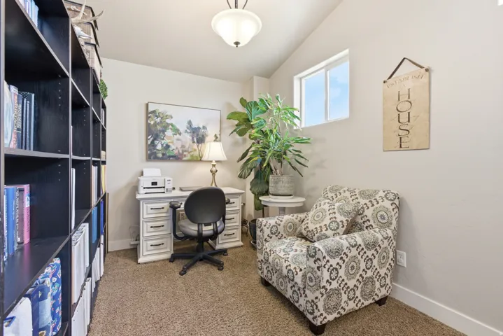 Dedicated office space with vaulted ceiling and neutral wall paint