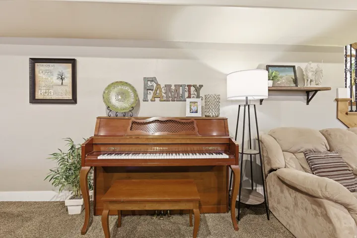 Neutral-toned wall with carpeted flooring
