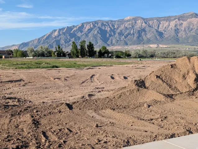 Expansive land parcel featuring level terrain, clear skies, and a distant mountain range