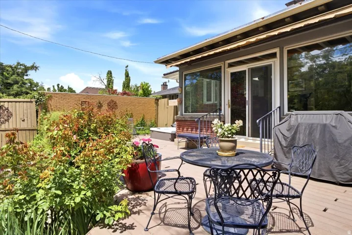 Outdoor deck space featuring a sliding glass door entry and large windows