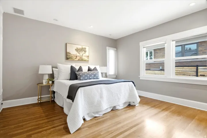 Hardwood flooring with neutral wall tones and recessed lighting