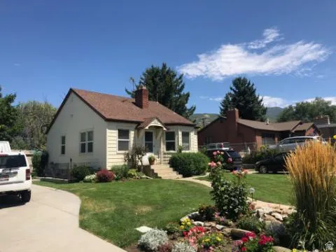 Bungalow-style house featuring a front yard