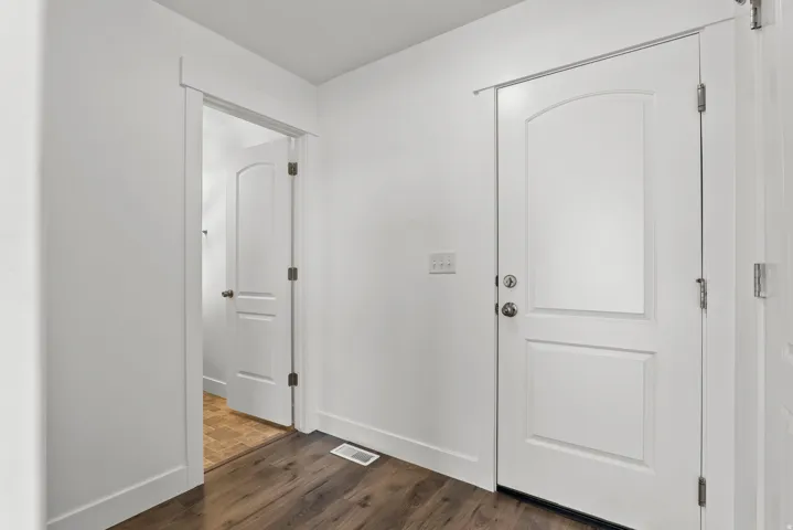 Entryway featuring wood-finish flooring and white baseboards
