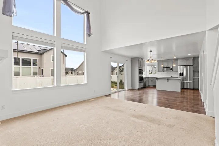 Two-story living area with expansive windows and vaulted ceilings