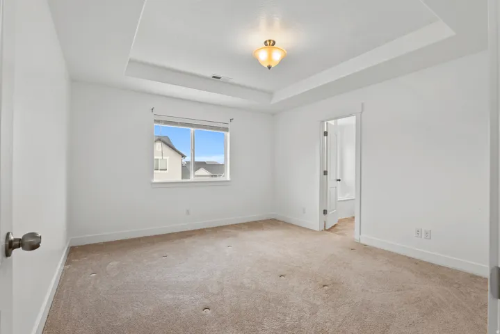 Neutral tone carpeting complements the white walls and trim