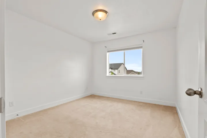Bright room with light beige carpeting and white walls