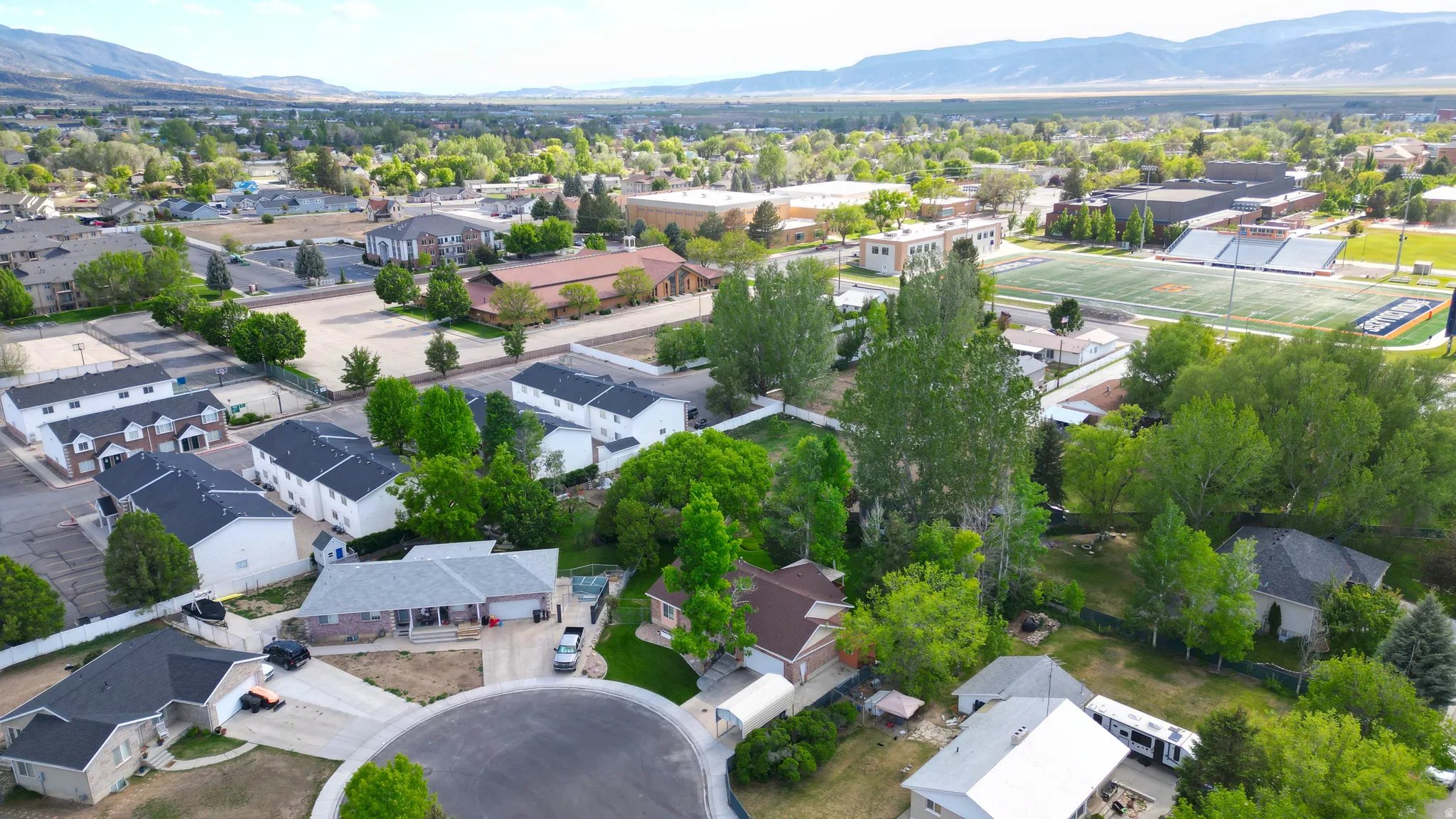 Aerial perspective showcasing a residential neighborhood with varied housing styles and mature landscaping