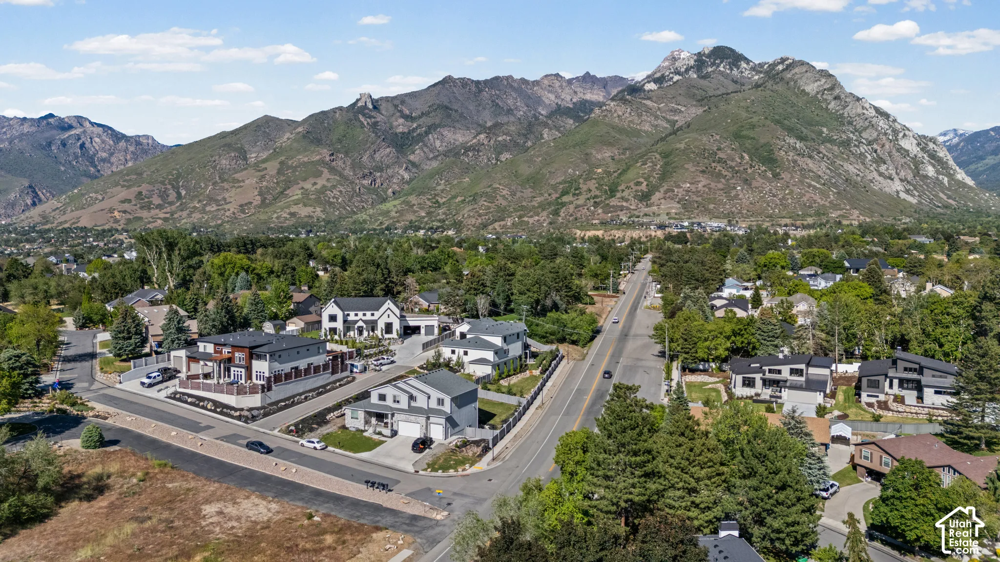 Aerial perspective showcasing a residential neighborhood with prominent mountain scenery