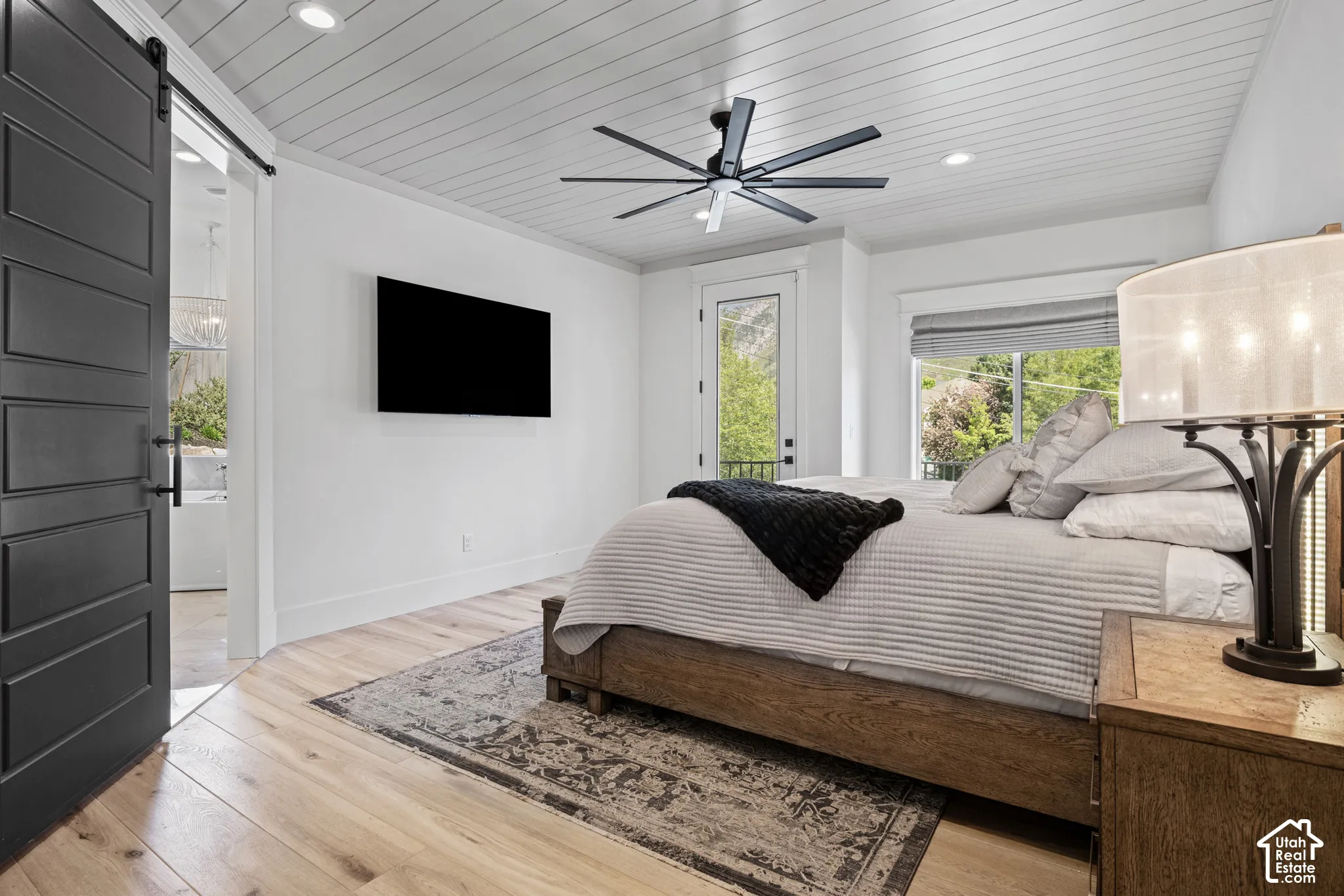Bedroom featuring wood-finish flooring, a contemporary ceiling fan, and a shiplap ceiling