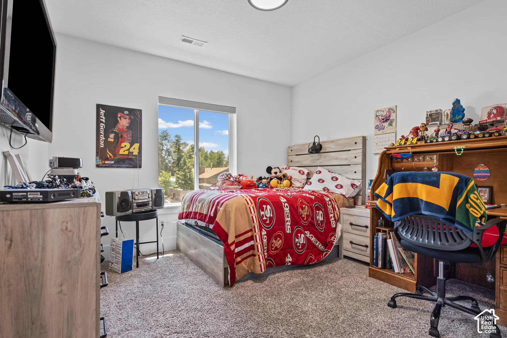 Bedroom featuring a large window, light gray carpet, and a white ceiling