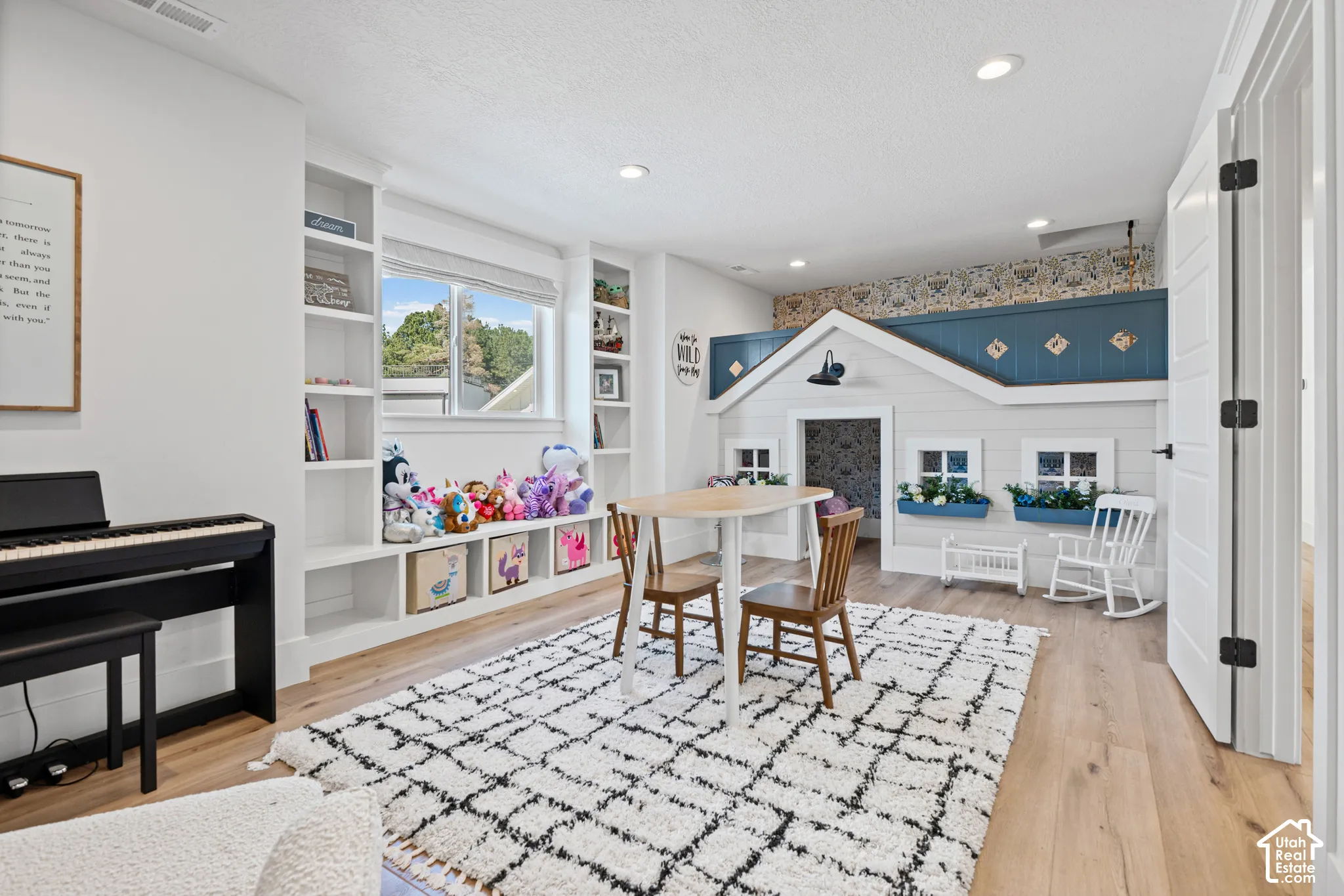 Spacious room featuring light wood-finish flooring, recessed lighting, and a built-in playhouse structure