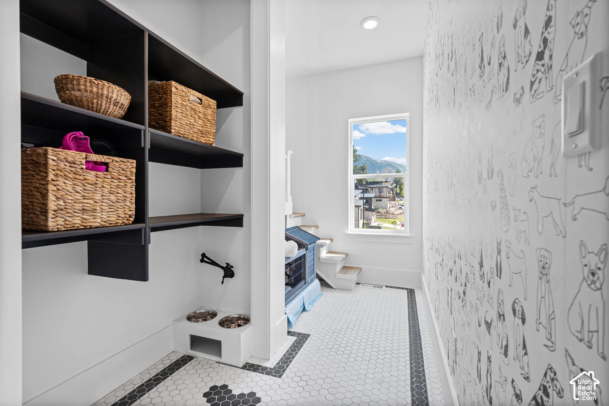 Custom built-in shelving with integrated pet feeding station and wall-mounted faucet