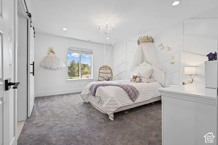 Spacious room featuring plush gray carpeting and a prominent window
