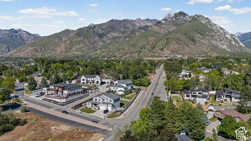 Aerial perspective showcasing a residential neighborhood with prominent mountain scenery