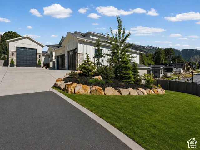 Modern home exterior featuring vertical white siding and stone accents