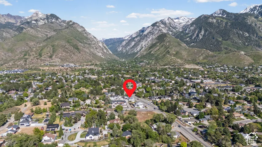 Aerial perspective showcasing the residential community set against a backdrop of prominent mountains, some with visible snowcaps